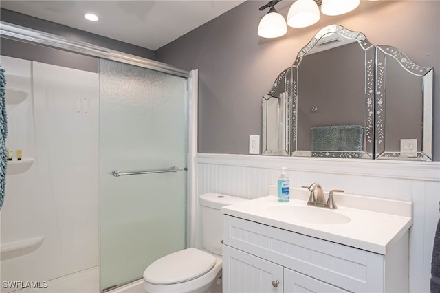 bathroom with vanity, toilet, and an enclosed shower