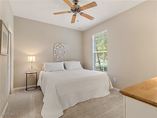 bedroom with light carpet and ceiling fan