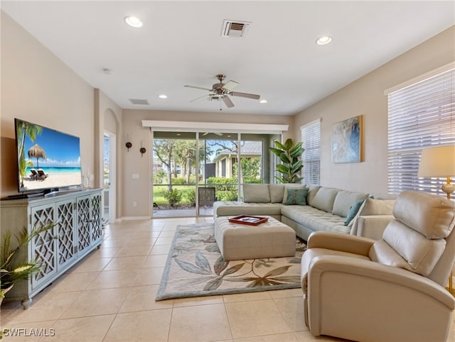 tiled living room with ceiling fan