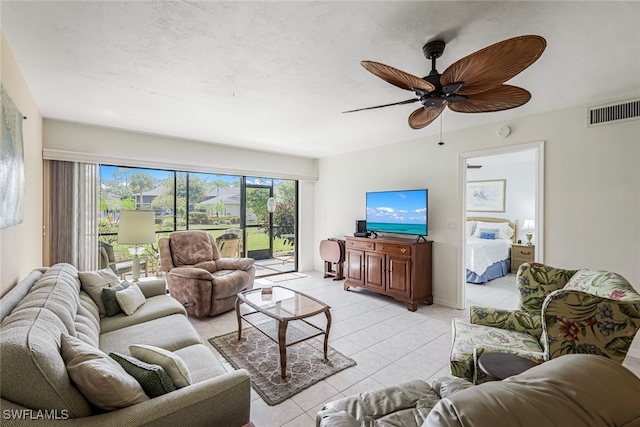 living room featuring ceiling fan and light tile patterned floors