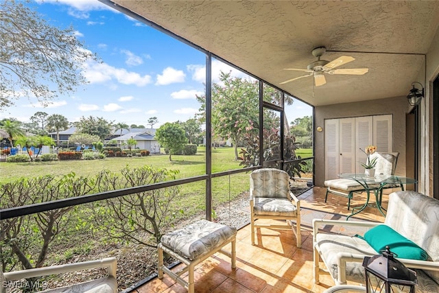 sunroom / solarium featuring ceiling fan