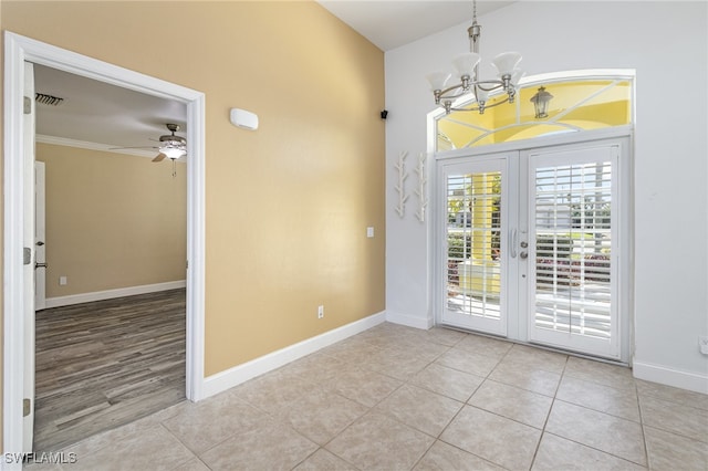 interior space with french doors, ceiling fan with notable chandelier, and ornamental molding