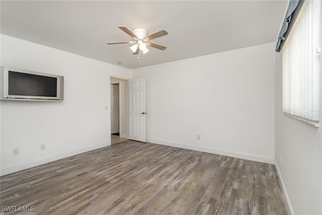 empty room featuring ceiling fan and hardwood / wood-style floors