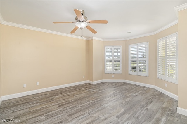 empty room with hardwood / wood-style floors, ceiling fan, and crown molding