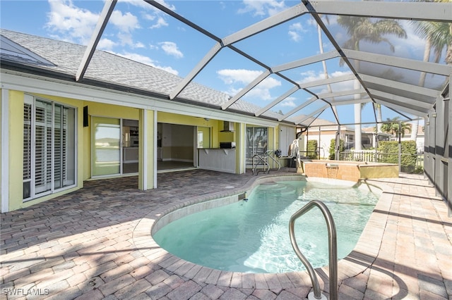 view of pool with pool water feature, a lanai, a jacuzzi, and a patio