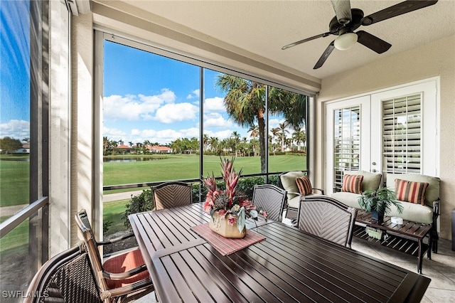 sunroom / solarium with ceiling fan and french doors