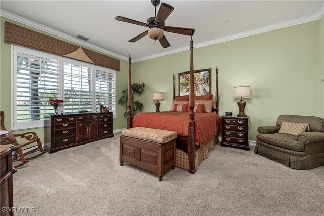 carpeted bedroom with ceiling fan and crown molding