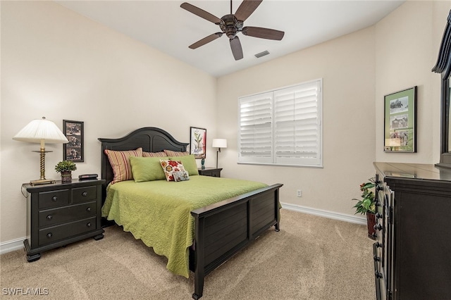 bedroom with baseboards, visible vents, ceiling fan, and light colored carpet