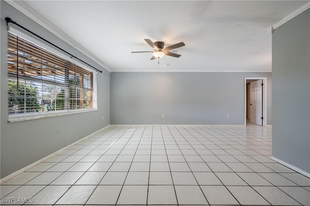 tiled empty room featuring ceiling fan and ornamental molding