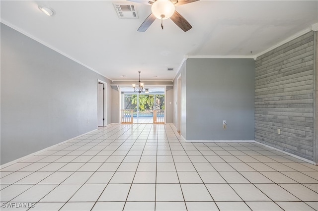 tiled spare room with brick wall, ceiling fan with notable chandelier, and ornamental molding