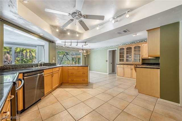 kitchen featuring appliances with stainless steel finishes, light tile patterned floors, plenty of natural light, and sink