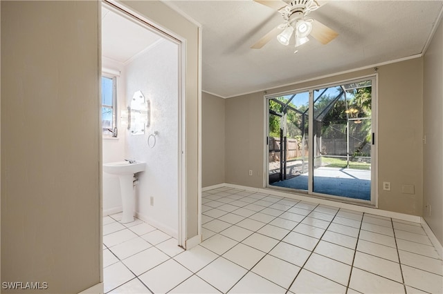 unfurnished room with light tile patterned flooring and ornamental molding