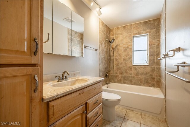 full bathroom with tile patterned flooring, vanity, toilet, and tiled shower / bath