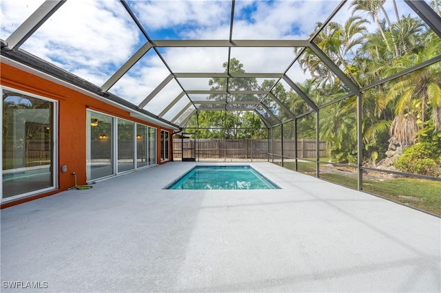 view of swimming pool with a patio area and glass enclosure