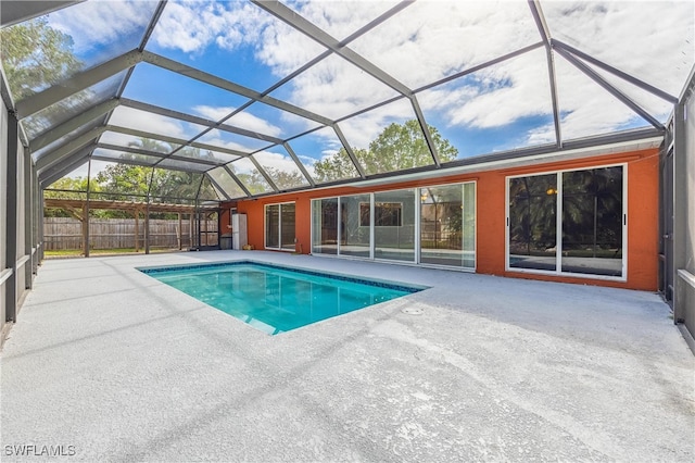 view of pool with a lanai and a patio