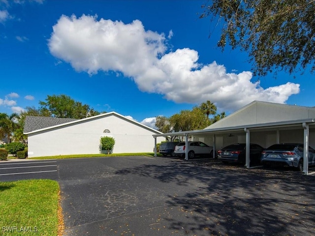 view of vehicle parking with a carport