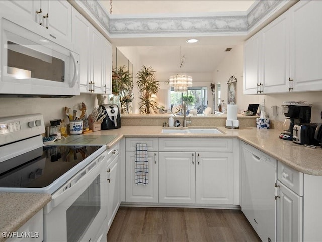 kitchen featuring white cabinetry, sink, and white appliances