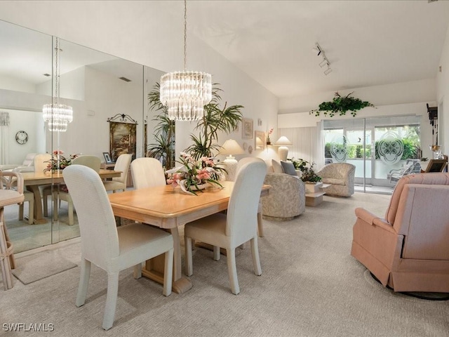 dining area with light carpet, track lighting, high vaulted ceiling, and a chandelier