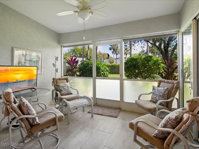 sunroom / solarium featuring ceiling fan