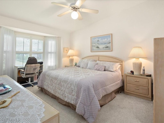 carpeted bedroom with ceiling fan and lofted ceiling