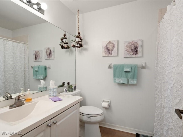 bathroom featuring hardwood / wood-style flooring, vanity, and toilet