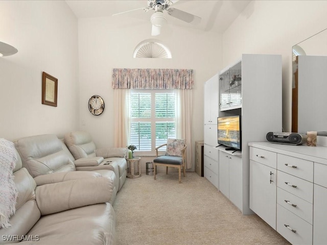 living room featuring high vaulted ceiling, light colored carpet, and ceiling fan