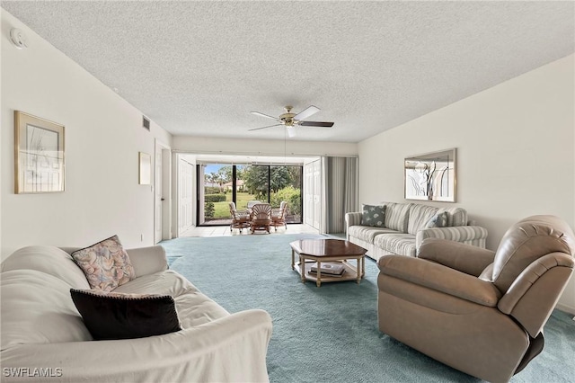 living room featuring ceiling fan, a textured ceiling, and carpet flooring