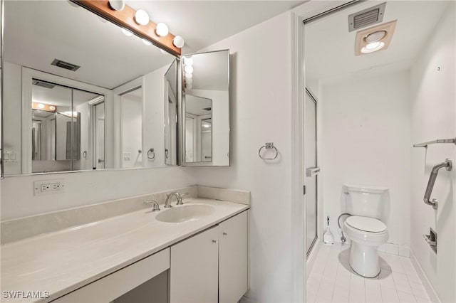 bathroom featuring walk in shower, vanity, tile patterned flooring, and toilet