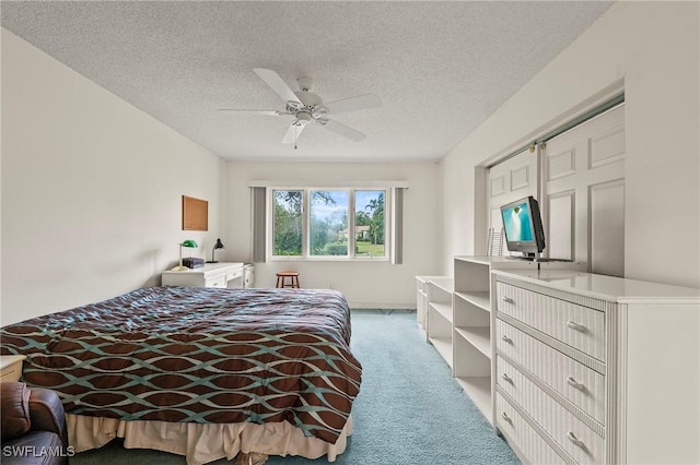 bedroom with light carpet, ceiling fan, a textured ceiling, and a closet