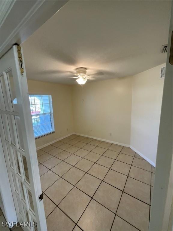 2917 43rd St W, Lehigh Acres, FL 33971 - unfurnished room with light tile patterned floors, a ceiling fan, and baseboards