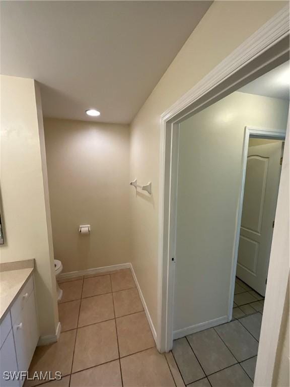 bathroom featuring tile patterned floors, vanity, and toilet