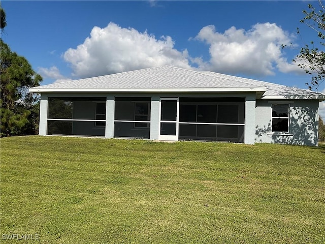 2917 43rd St W, Lehigh Acres, FL 33971 - rear view of property featuring a sunroom, a lawn, and stucco siding
