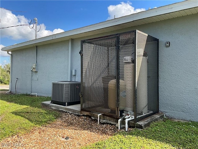 2917 43rd St W, Lehigh Acres, FL 33971 - view of side of home with stucco siding and a central AC unit