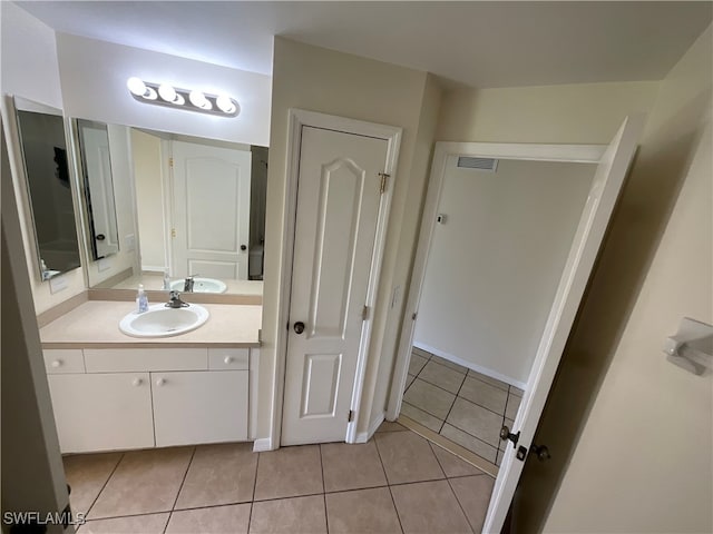 bathroom featuring tile patterned flooring and vanity