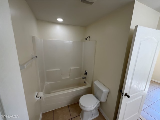 bathroom with tile patterned flooring, toilet, and bathtub / shower combination