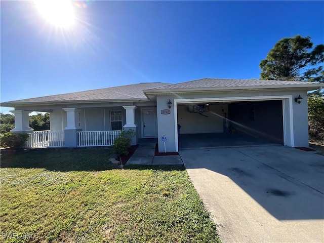 2917 43rd St W, Lehigh Acres, FL 33971 - single story home featuring a porch, driveway, an attached garage, a front yard, and stucco siding