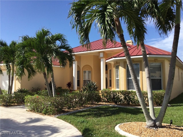 mediterranean / spanish home featuring a front yard