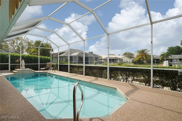 view of swimming pool featuring a lanai