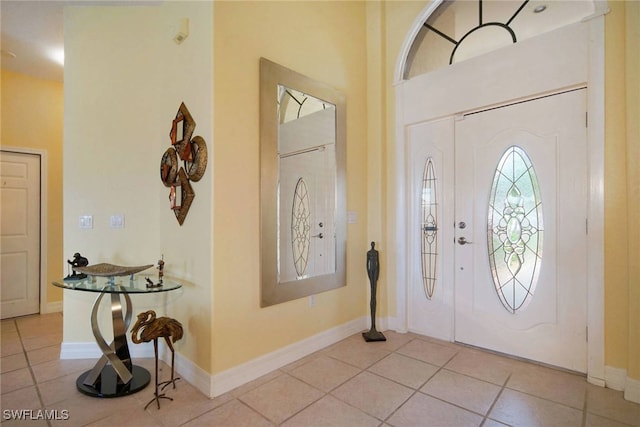 entryway with light tile patterned flooring