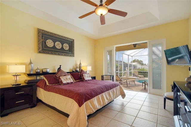 bedroom featuring a tray ceiling, ceiling fan, and light tile patterned flooring