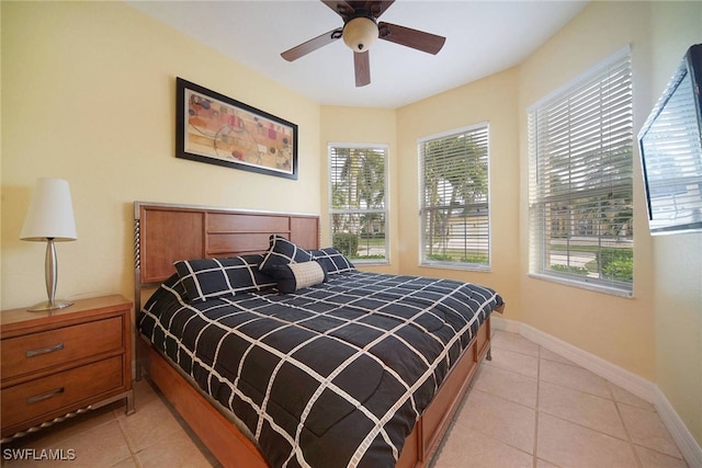 bedroom with ceiling fan and light tile patterned flooring