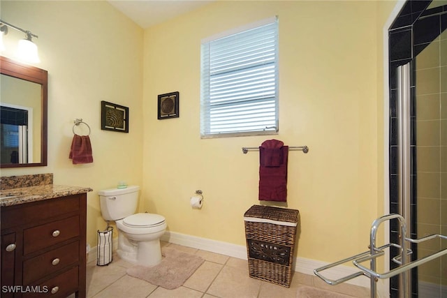 bathroom with tile patterned flooring, vanity, a shower with door, and toilet