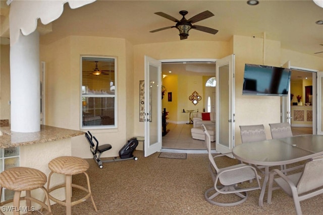 dining area featuring ceiling fan, carpet floors, and french doors