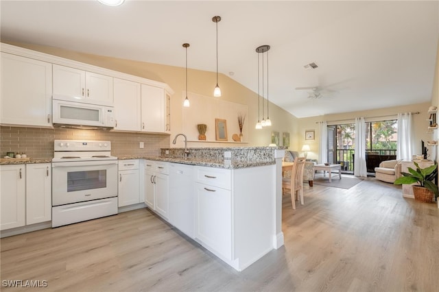 kitchen featuring vaulted ceiling, white cabinets, and white appliances