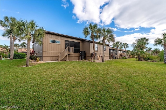 rear view of property with a yard