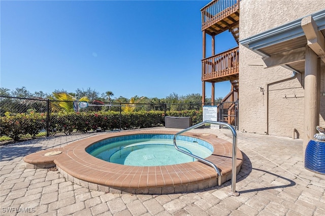 view of swimming pool featuring a community hot tub