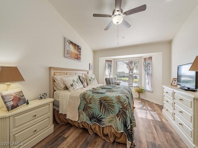 bedroom with ceiling fan, dark wood-type flooring, and vaulted ceiling