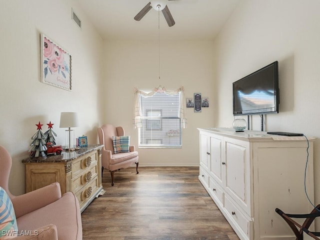 sitting room featuring dark hardwood / wood-style floors and ceiling fan