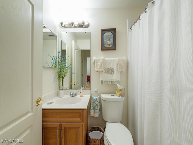 bathroom with vanity and toilet