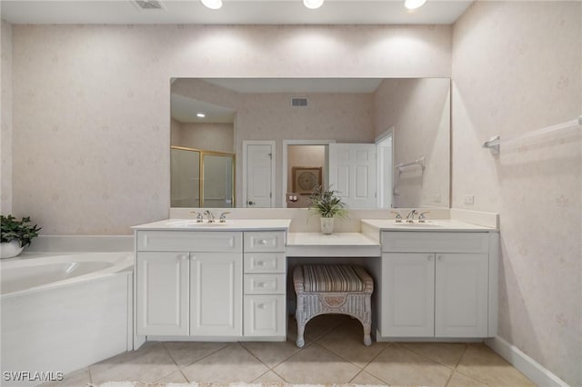 bathroom with tile patterned flooring, vanity, and separate shower and tub